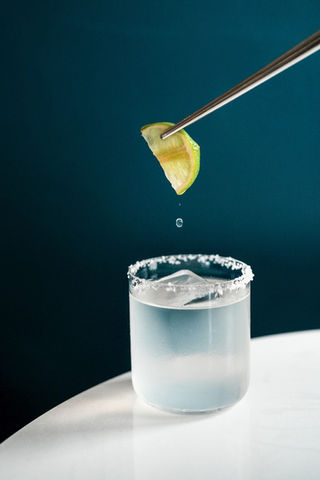 A fresh lime garnish above a cocktail at Tides