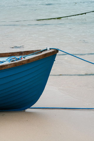 A blue fishing boat floating off the St Ives coast